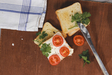 Wall Mural - Closeup of sandwiches with toast bread, tomatoes, cheese, and parsley.