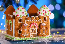 Beautiful Gingerbread House On Table Against Blurred Background
