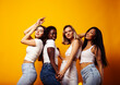 © iordani - diverse multi nation girls group, teenage friends company cheerful having fun, happy smiling, cute posing on yellow background, lifestyle people concept, african-american, asian and caucasian