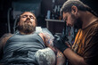 © Mr. Prof - Tattooer showing process of making a tattoo in tattoo studio
