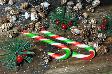 Wall Mural - sweet candy canes on a wooden table with festive decorations.