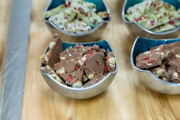 Sticker - Closeup shot of various snacks in different bowls on a wooden surface