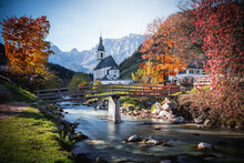 Scenic View Of A Bridge Over A River Near Parish Church Of St. Sebastian In Berchtesgaden, Germany