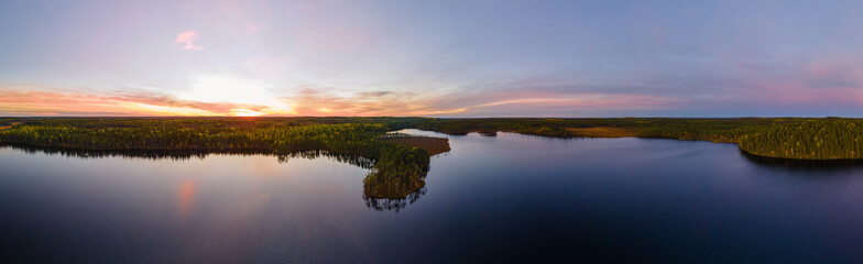 Canvas Print - Panoramic shot of colorful sunset over the Aulanko nature reserve in Hameenlinna, Finland