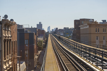 Sticker - Outdoors train railway surrounded by buildings on a clear sky background