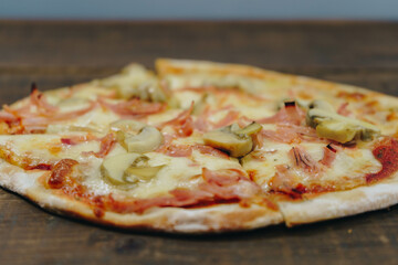 Sticker - Closeup shot of a homemade thin pizza on a wooden board