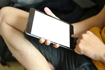 Poster - Close-up image of a young man relaxing with a white blank screen digital tablet.