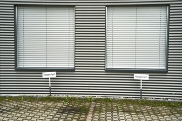 Canvas Print - Scenic shot of a building with a linear black and white design and closed windows