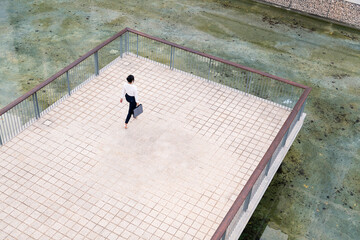 top view of a businesswoman walking in a city park