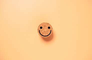 Wall Mural - Smile face on circle wooden block on orange background for happy mindset concept.