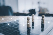 © Danai - Business people network connection strategy planning concept, Wooden doll model on chase board on executive office desk with network communication graphic