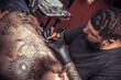 © Mr. Prof - Master tattooist designs a tattoo tatoo salon
