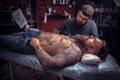 © Mr. Prof - Master of the art of tattooing during a tattoo artist session salon