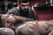 © Mr. Prof - Master of the art of tattooing demonstrates the process of getting tattoo in the salon