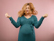 © rubchikova - Portrait of a pregnant woman in a pink background