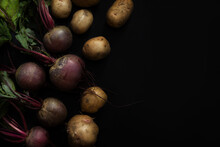 Beets And Potatoes On A Black Background. Red Beets And Golden Potatoes. View From Above.