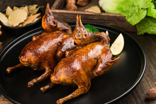 Traditional Cantonese Roast Pigeon On A And White Porcelain Plate