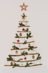 Christmas creative decoration - homemade wooden hanging christmas tree on the wall