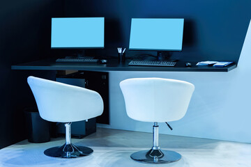 Poster - an office table next to two armchairs. blank monitors in office. control room with computers. white 