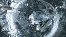 Detail Shot Of Ice Beying Dropped Into Vodka Drink