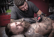 © Mr. Prof - Professional tattooist demonstrates the process of getting tattoo in tattoo parlour