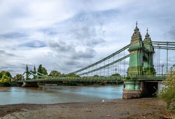 View of Hammersmith Bridge, a Grade II listed suspension bridge that crosses the River Thames, connecting Hammermith to Barnes, in west London.