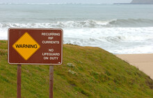 Rip Currents Warning Sign By Ocean.