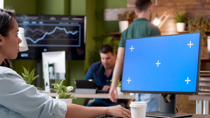 Poster - Manager looking at mock up green screen chroma key computer with isolated display typing management strategy planning business project in startup office. Businesswoman working at company presentation