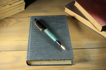 Poster - Closeup of old books and fountain pen on top of a book