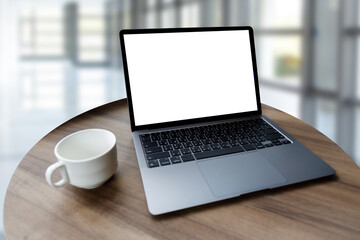 Poster - Blank screen laptop computer modern man use room laptop with blank white desktop screen with coffee cup on wooden table in cafe
