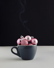 Wall Mural - Coffee cup with pink Christmas baubles decoration and steam. Creative winter holidays concept. Minimal coffee adiction concept.