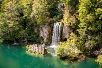 Sticker - Scenic view of a small waterfall in Plitvice Lakes National Park on a sunny day, Croatia