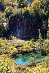 Sticker - Vertical scenic view of a small waterfall in Plitvice Lakes National Park on a sunny day, Croatia