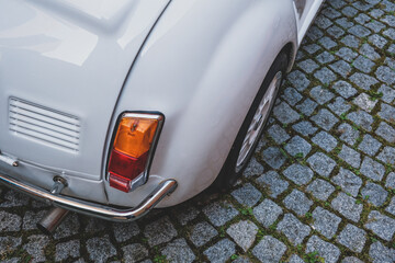 Wall Mural - High angle shot of a  white oldtimer cabrio car backlight