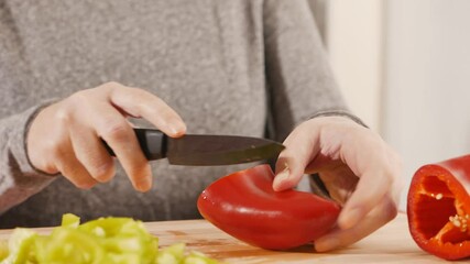 Sticker - A closeup shot of female hands cutting fresh vegetables in HD