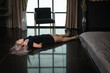 Crime scene simulation: dead girl with hands tied lying on the floor. She was strangled with a rope...