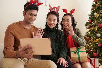 Poster - Smiling family members waving with hands when video calling relatives from another city to wish merry Christmas