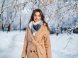 © nikitaat - girl in a beige coat in winter in a snowy park