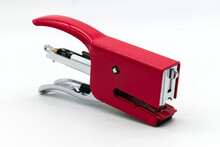 Red metal stapler isolated on white background