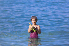 Senior Asian Woman With A Mask For Snorkeling In The Sea.
