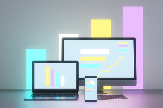 Abstract light neon designer desktop with glowing laptop computer monitors, smartphone screen and business charts, graphs and diagrams. Finance, stock and economic growth concept. 3D Rendering.