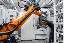 Maintenance Engineer Repairing Robotic Arm In Industry