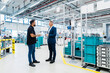© Westend61 - Maintenance engineer discussing with businessman in modern factory