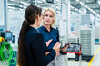 © Westend61 - Businesswomen having discussion at automated factory