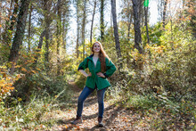 Young Woman With Hand On Hip Standing In Forest