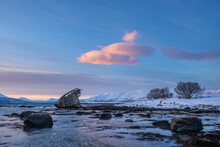 Shipwreck Lying On Shore Of Secluded Fjord At Winter Dawn