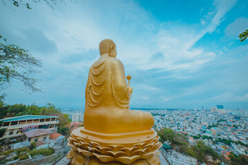 Back view of Golden Buddha statue's hand holding lotus at Chon Khong Monastery.