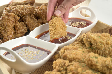 Wall Mural - Closeup shot of Korean fried chicken with dipping sauce isolated on a white background