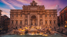 Scenic Shot Of The Historically Famous Trevi Fountain During The Colorful Sunset In Rome, Italy