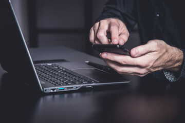 Sticker - Businessman using a smartphone and notebook in a moddy office